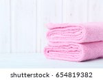Pink towels on white wooden table