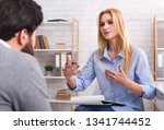 Psychologist having session with her patient in office, giving him advice about his life