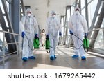 Small photo of Specialist in hazmat suits cleaning disinfecting coronavirus cells epidemic, pandemic health risk