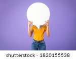 Information, Thought, Quote And Opinion Concept. Young woman hiding her face behind blank white speech bubble, isolated on purple studio background. Empty space for text or feedback on balloon circle