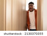 Small photo of Shocked African American Man Opening The Door Looking At Something Shocking Standing With Opened Mouth At Home. Overwhelmed Guy Expressing Embarrassment. Omg, Negative News Concept