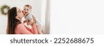 Small photo of Family Offer. Wide Banner With Happy Mother Kissing Her Adorable Baby, Extended Horizontal Shot Of Loving Young Mom Bonding With Infant Child At Home, Enjoying Motherhood, Panorama With Copy Space