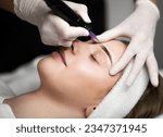 Small photo of Cosmetologist applying permanent makeup on eyebrows of beautiful young female, calm attractive woman getting eyebrow tattoo by professional artist, lying on table with closed eyes, enjoying procedure