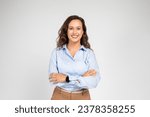 Small photo of Smiling confident calm millennial european business woman, teacher in formal wear with crossed arms, isolated on gray background studio background. Work, education, ad and offer