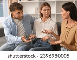 Small photo of Misunderstanding In Friendship. Three Angry Friends Having Quarrel Arguing Sitting On Sofa At Home. Millennial Romantic Couple and Female Friend Engage in Heated Argument Having Conflict