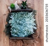 Small photo of Beautiful background for newborn photosession. Digital composite with wooden box filled with fur and standing on sackcloth