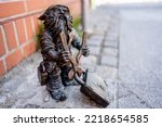 Small photo of Dwarf with a padlock near bridge. Small bronze figures of gnomes on the streets of Wroclaw. Europe