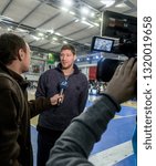 Small photo of ODESSA, UKRAINE - February 16, 2019: Interview of captain of Ukrainian national basketball team Vyacheslav Kravtsov during opening of children's championship. Basketball player Vyacheslav Kravtsov