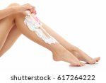 Woman shaving her legs isolated on white