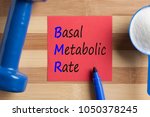 Small photo of BMR Basal Metabolic Rate written on note. Acronym. Health concept.