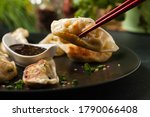 Original Japanese dumplings Gyoza with chicken and vegetables. Front view. Dark blue backgrund.