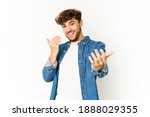 Small photo of Young arab man on white background pointing with finger at you as if inviting come closer.