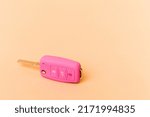 Pink car keys isolated on beige ...