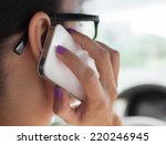 Woman talking on the phone while driving a car