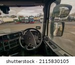Small photo of Strensham, Worcestershire UK - January 31 2022, Editorial Illustration Heavy Goods Semi Truck View of the Drivers Cockpit and Steering wheel and side Mirrors whilst parked up in a Truckstop.