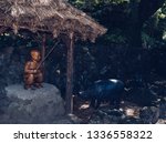 Small photo of Jeju island, South Korea, september 09, 2015: wooden sculpture of boy swineherd and black pig famous on Jeju island