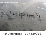 image of the words Help Me written in dust on car