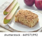 Small photo of Rhubarb coffee cake with apples. Homemade coffeecake. Freshly baked pastry with streusel topping. Isolated. Selective focus.