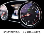 Close up shot of a tachometer in a car. Car dashboard. Dashboard details with indication lamps. Car instrument panel. Dashboard with speedometer, tachometer, odometer. Car inside