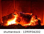 Small photo of Background of burning hot coals.Coals in the brazie.Embers and fire above firebrand in hearth, shallow DOF. Embers in the fireplace