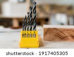 Close up set of metal drills of various sizes for electric drill on work table with carpentry workshop, Screwdriving Bits. Selective focus