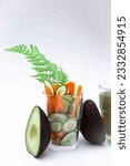 Small photo of Vegetables in a glass, natural ingredients for preparing a vegetarian drink of vivacity and energy