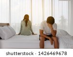 Small photo of Asian young couple with relationship problem appear depressed and disappointed And sit back and forth in the bedroom Background textures concept.