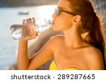 Young Woman Drinking Sparkling...