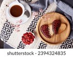 Heart shaped St Valentines cookies with raspberry taste with cup of coffee. Romantic holiday food background. Top view.