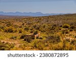 Small photo of Old livestock feeding trough in the Little Karoo veldt with the Swartberg Mountains in the background in the Western Cape, South Africa