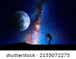 Small photo of Man looking at the stars and moon through a telescope