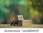 Small photo of Logistic and cargo freight concept: Fork-lift truck moves a pallet with Paper boxes. depicts delivery management from the point of origin to point of consumption according to needs of customers