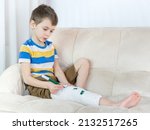 little child with a broken leg... | Shutterstock . vector #2132517265