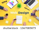 Web design team work on project concept. Yellow desk with web design text. Top view, flat lay.