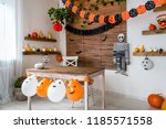 Halloween theme decorated living room. Lifestyle Halloween season family house interior. Traditional Halloween decorations background.