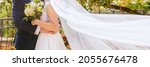 Small photo of Cropped shot of an affectionate young newlywed couple embracing eachother on their wedding day. Just married husband and wife panoramic banner. Wedding and love concept.