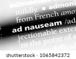 Small photo of ad nauseam word in a dictionary. ad nauseam concept.