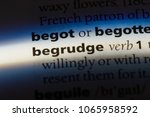Small photo of begrudge word in a dictionary. begrudge concept.