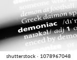 Small photo of demoniac word in a dictionary. demoniac concept