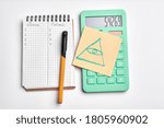 Small photo of calculater ,pen and blank notebook for office on white background isolated. illuminati sign