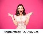 Surprised young woman shouting over pink background. Looking at camera