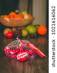 Small photo of February 10th, 2018, Cork, Ireland - Babybel cheese on top of a wooden table with healthy fruit in the background