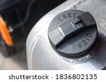 Black plastic cap of aluminum gas tank in silver color with the inscription "DIESEL". The fuel tank of the truck is closed with a cap. The concept of rising fuel prices in the world.
