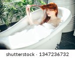 Small photo of Angry, disaffected red-haired caucasian woman being unsatisfied with hair condition after perming or coloration procedure at beauty shop, touching her hair with disgust while taking a bath.