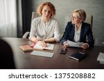 Small photo of Group of two female corporate mentors check the knowledge of the woman trainee at the end of the trial period