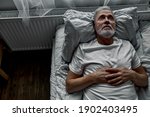 Lonely Senior Lying On Bed In A ...