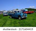 Small photo of 29th May 2022- A 1964 Land Rover 109"-4 Cyl pickup truck being driven at a classic car show near Newcastle Emlyn, Ceredigion, Wales, UK.