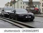 Small photo of 20th February 2024- A stylish Audi A7 S Line Black Edition Tdi Quattro, five door hatchback car, parked in the town center at Carmarthen, Carmarthenshire, Wales, UK.