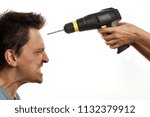Small photo of Drill in female hands is aimed at the forehead of an angry, and frightened man. The concept of female grumbling and negative reaction of a man. Family dissension. Wife drills her brain to her husband