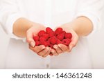 Woman giving a handful of raspberries